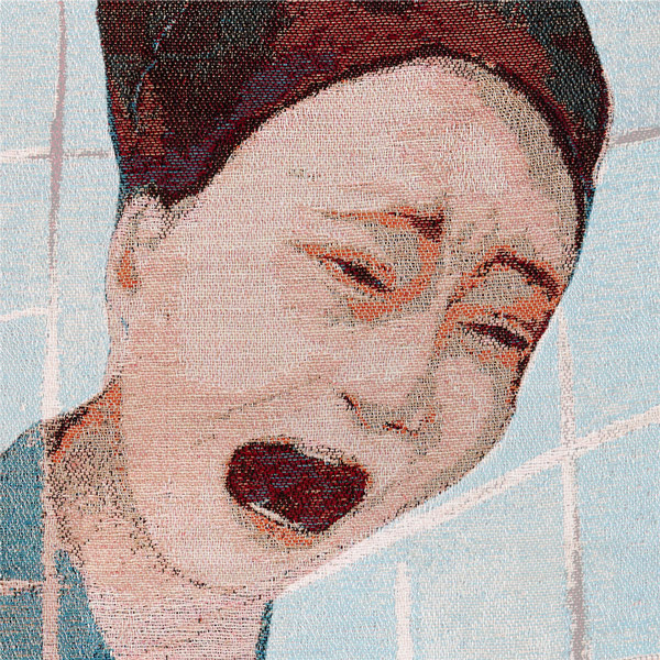 Zoomed section of the Eyes Forced Shut tapestry panel which highlights the anguished face of the main figure in the centre of the artwork.